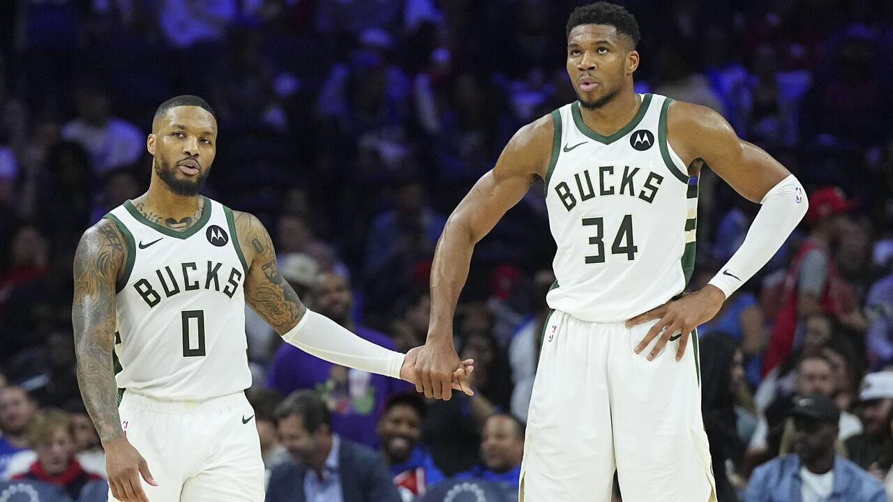 PHILADELPHIA, PENNSYLVANIA - OCTOBER 23: Damian Lillard #0 of the Milwaukee Bucks celebrates with Giannis Antetokounmpo #34 against the Philadelphia 76ers in the second half at the Wells Fargo Center on October 23, 2024 in Philadelphia, Pennsylvania. The Bucks defeated the 76ers 124-109. NOTE TO USER: User expressly acknowledges and agrees that, by downloading and/or using this photograph, user is consenting to the terms and conditions of the Getty Images License Agreement.