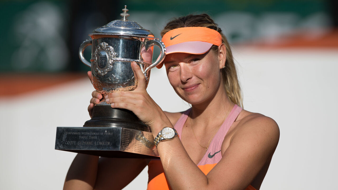 Maria Sharapova of Russia poses with the Coupe Suzanne Lenglen trophy following her victory in the women's singles final match against Simona Halep of Romania on day fourteen of the French Open at Roland Garros on June 7, 2014 in Paris.