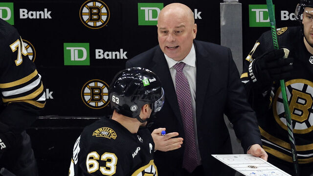 Boston, MA - January 24: Boston Bruins head coach Jim Montgomery talks to LW Brad Marchand during a third period timeout. The Bruins lost to the Carolina Hurricanes, 3-2.