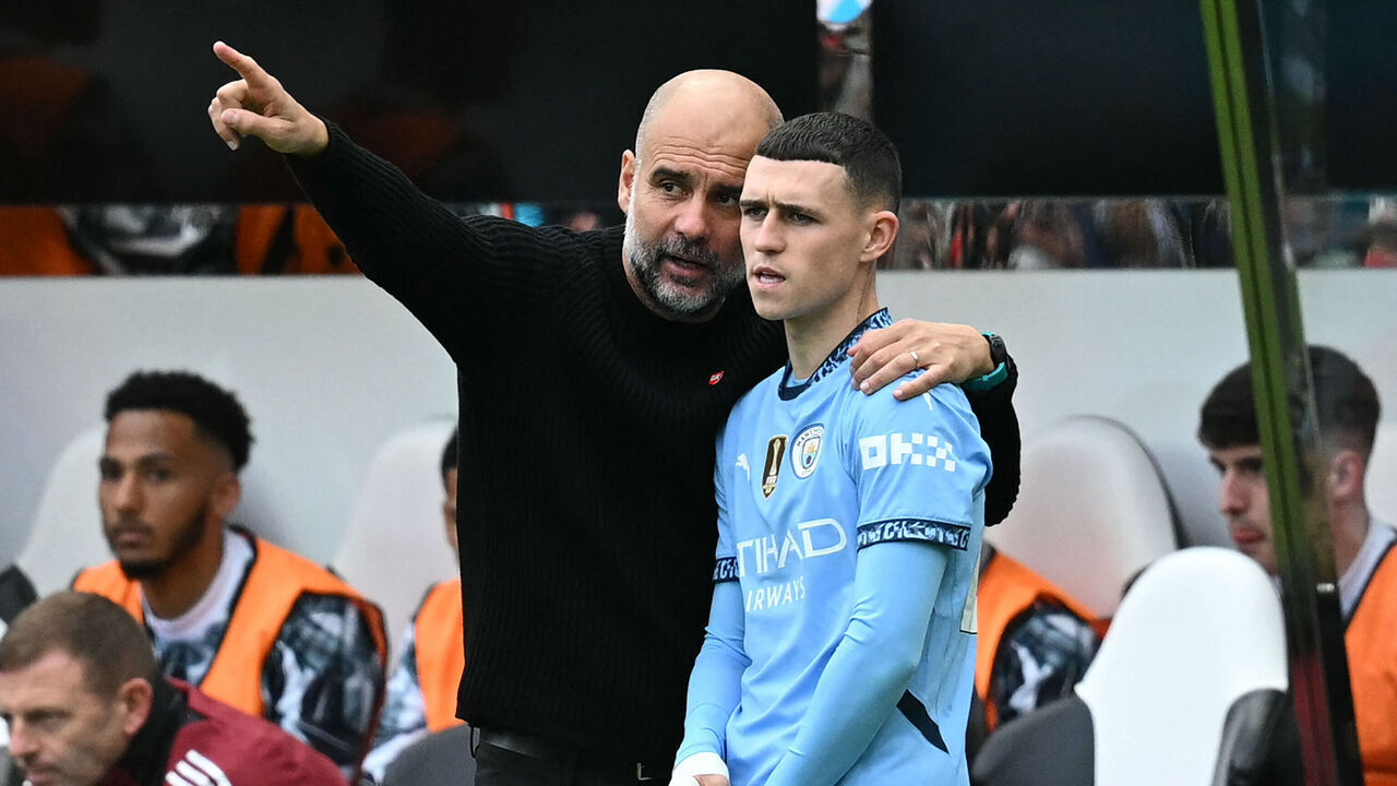 Manchester City's Spanish manager Pep Guardiola (L) speaks with Manchester City's English midfielder #47 Phil Foden (R) as he prepares to come on as a substitute during the English Premier League football match between Newcastle United and Manchester City at St James' Park in Newcastle-upon-Tyne, north-east England on September 28, 2024.