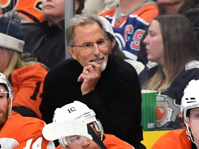 EDMONTON, CANADA - OCTOBER 15: Referee Garrett Rank #7 and Philadelphia Flyers head coach John Tortorella look on during the third period of the game at Rogers Place on October 15, 2024, in Edmonton, Alberta, Canada.