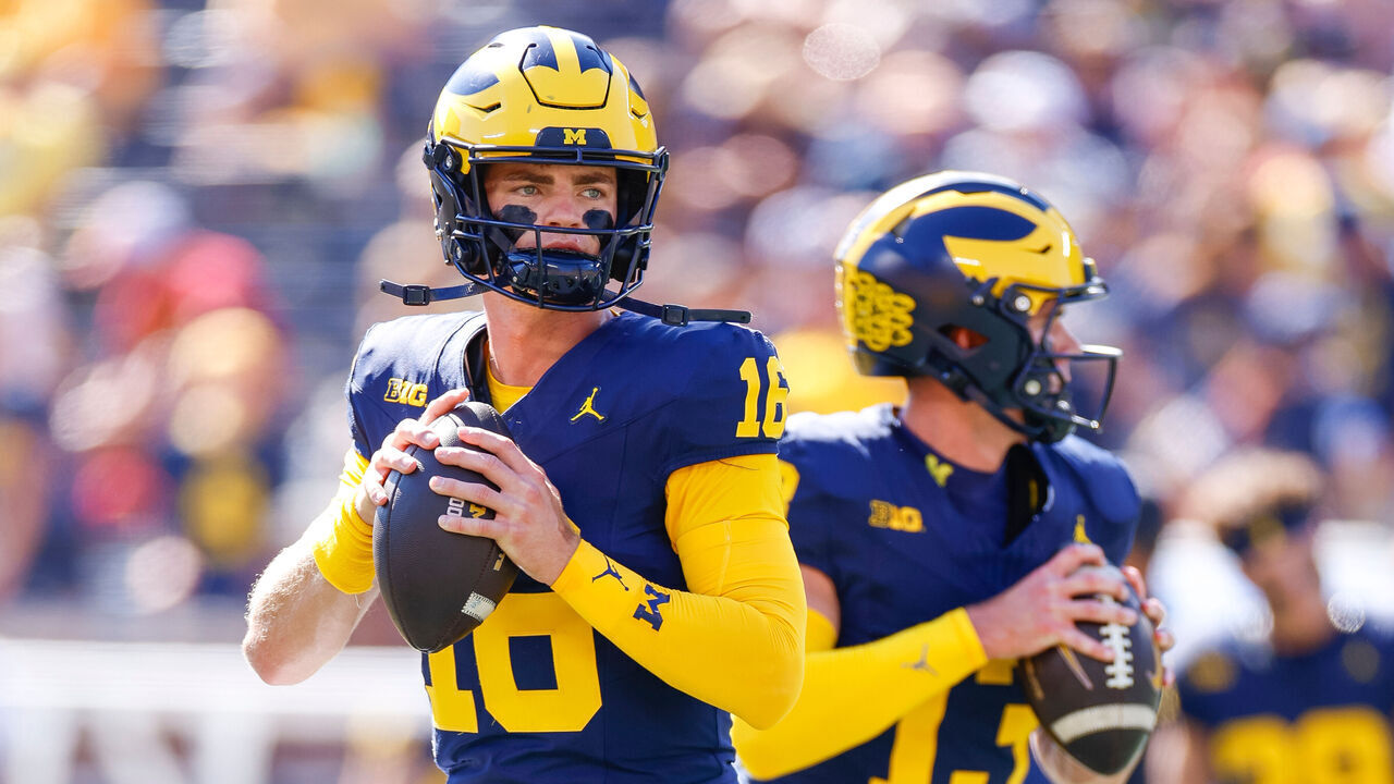 ANN ARBOR, MICHIGAN - SEPTEMBER 21: Davis Warren #16 of the Michigan Wolverines warms up prior to a game against the USC Trojans at Michigan Stadium on September 21, 2024 in Ann Arbor, Michigan.