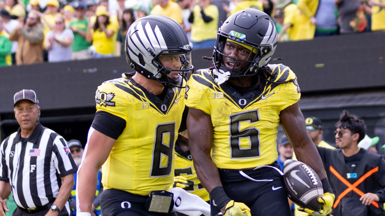 EUGENE, OREGON - OCTOBER 26: Running back Noah Whittington #6 of the Oregon Ducks runs celebrates his touchdown with teammate quarterback Dillon Gabriel #8 of the Oregon Ducksagainst the Illinois Fighting Illini during the first half at Autzen Stadium on October 26, 2024 in Eugene, Oregon.