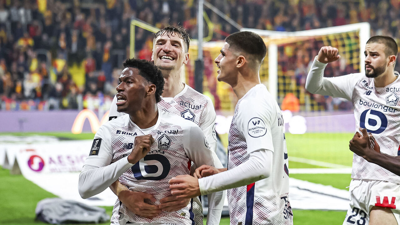 Lille's Canadian forward #09 Jonathan David (L) celebrates scoring his team's first goal during the French L1 football match between RC Lens and Lille LOSC at Stade Bollaert-Delelis in Lens, northern France on October 26, 2024.