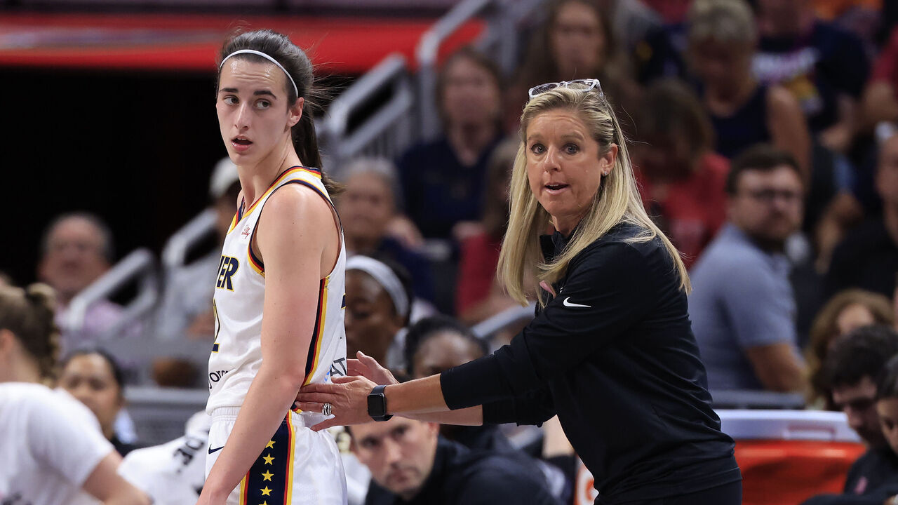 INDIANAPOLIS, INDIANA - AUGUST 28: Head coach Christie Sides holds back Caitlin Clark #22 of the Indiana Fever during the first quarter against the Connecticut Sun at Gainbridge Fieldhouse on August 28, 2024 in Indianapolis, Indiana.