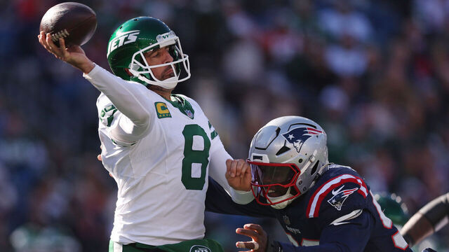 FOXBOROUGH, MASSACHUSETTS - OCTOBER 27: Aaron Rodgers #8 of the New York Jets throws a pass against Joshua Uche #55 of the New England Patriots during the third quarter at Gillette Stadium on October 27, 2024 in Foxborough, Massachusetts.