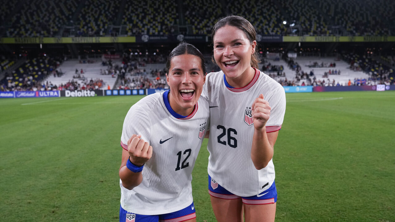 NASHVILLE, TENNESSEE - OCTOBER 27: Emily Sams #12 of the United States celebrates with Emma Sears #26 of the United States after playing Iceland at GEODIS Park on October 27, 2024 in Nashville, Tennessee.