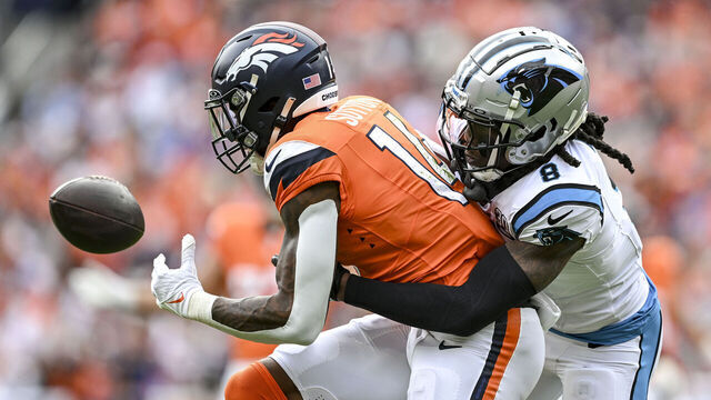 DENVER, CO - OCTOBER 27: Courtland Sutton (14) of the Denver Broncos drops a pass as Jaycee Horn (8) of the Carolina Panthers defends during the first quarter at Empower Field at Mile High in Denver on Sunday, October 27, 2024.