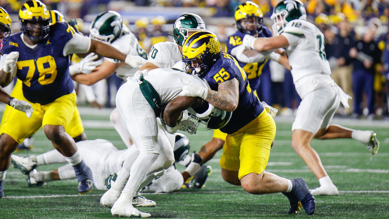 ANN ARBOR, MI - OCTOBER 26: Mason Graham #55 of Michigan tackles Nathan Carter #5 of Michigan State during a game between Michigan State University and University of Michigan at Michigan Stadium on October 26, 2024 in Ann Arbor, Michigan.