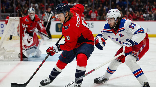 WASHINGTON, DC - OCTOBER 29: Jakob Chychrun #6 of the Washington Capitals and Mika Zibanejad #93 of the New York Rangers vie for the puck during the first period of the game at Capital One Arena on October 29, 2024 in Washington, DC.