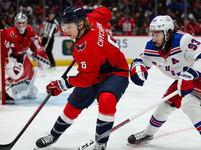 WASHINGTON, DC - OCTOBER 29: Jakob Chychrun #6 of the Washington Capitals and Mika Zibanejad #93 of the New York Rangers vie for the puck during the first period of the game at Capital One Arena on October 29, 2024 in Washington, DC.