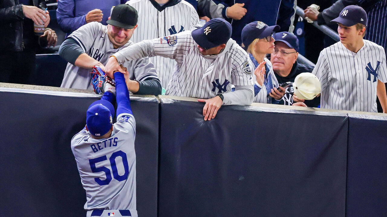 NEW YORK, NEW YORK - OCTOBER 29: Fans interfere with Mookie Betts #50 of the Los Angeles Dodgers as he attempts to catch a fly ball in foul territory during the first inning of Game Four of the 2024 World Series against the New York Yankees at Yankee Stadium on October 29, 2024 in the Bronx borough of New York City. The play resulted in an out.