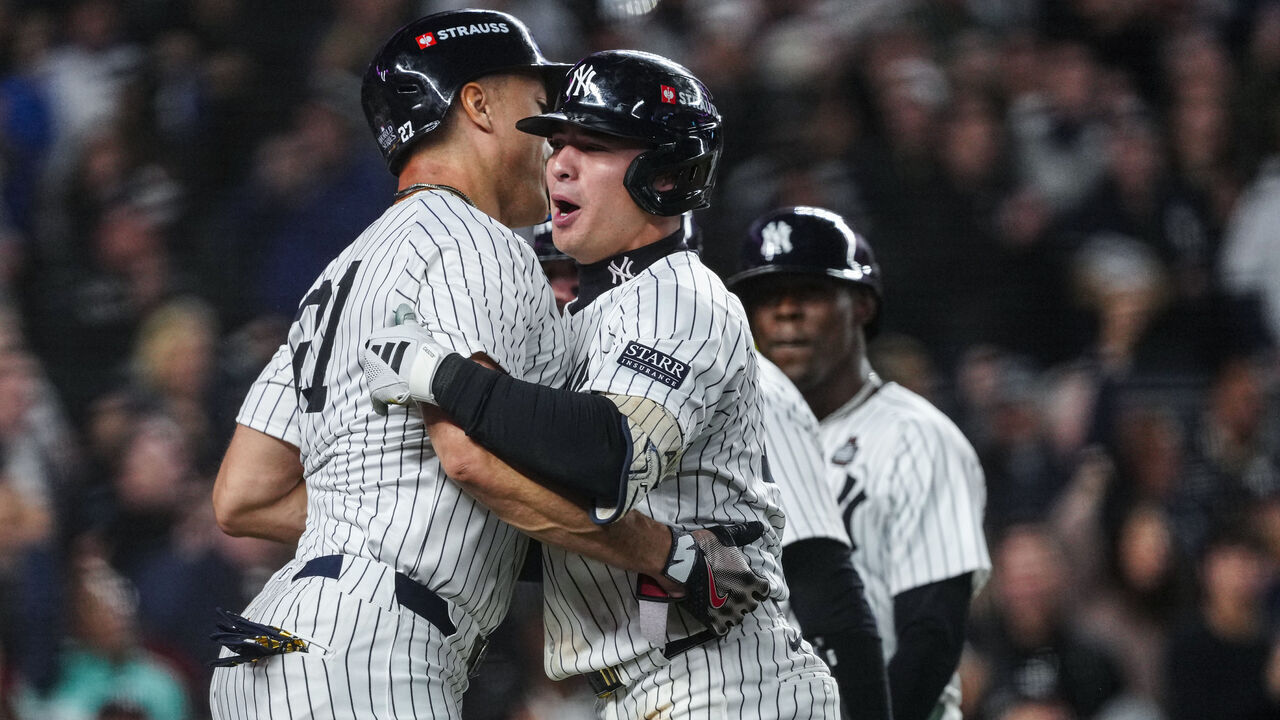 NEW YORK, NY - OCTOBER 29: Giancarlo Stanton #27 and Anthony Volpe #11 of the New York Yankees celebrate after Volpe's grand slam in the third inning of Game 4 of the 2024 World Series presented by Capital One between the Los Angeles Dodgers and the New York Yankees at Yankee Stadium on Tuesday, October 29, 2024 in New York, New York.