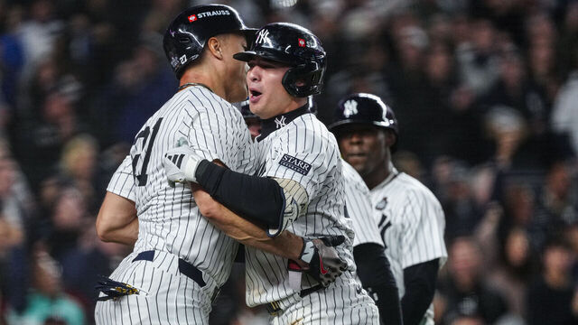 NEW YORK, NY - OCTOBER 29: Giancarlo Stanton #27 and Anthony Volpe #11 of the New York Yankees celebrate after Volpe's grand slam in the third inning of Game 4 of the 2024 World Series presented by Capital One between the Los Angeles Dodgers and the New York Yankees at Yankee Stadium on Tuesday, October 29, 2024 in New York, New York.