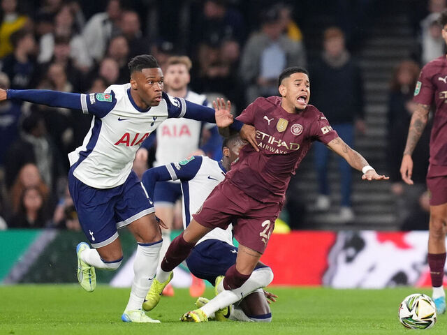 Manchester City's Savinho (right) is challenged by Tottenham Hotspur's Destiny Udogie (left) and Pape Matar Sarr during the Carabao Cup fourth round match at Tottenham Hotspur Stadium, London. Picture date: Wednesday October 30, 2024.