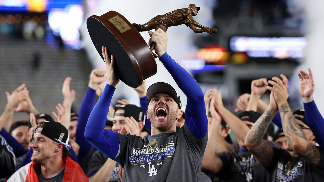 NEW YORK, NEW YORK - OCTOBER 30: Freddie Freeman #5 of the Los Angeles Dodgers celebrates with the MVP trophy after the Dodgers defeated the New York Yankees 7-6 in game 5 to win the 2024 World Series at Yankee Stadium on October 30, 2024 in the Bronx borough of New York City.