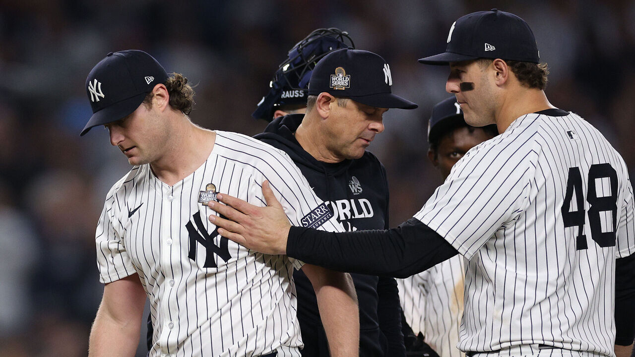 NEW YORK, NEW YORK - OCTOBER 30: Anthony Rizzo #48 of the New York Yankees pats starting pitcher Gerrit Cole #45 on the shoulder as Cole exits the game during the seventh inning of Game Five of the 2024 World Series against the Los Angeles Dodgers at Yankee Stadium on October 30, 2024 in the Bronx borough of New York City.