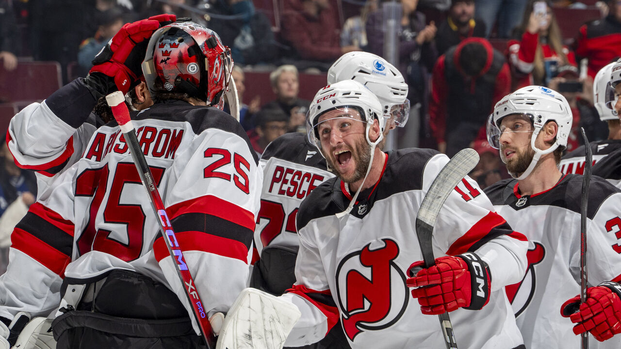 VANCOUVER, CANADA - OCTOBER 30: Jacob Markstrom #25 of the New Jersey Devils and Stefan Noesen #11 celebrate their NHL game win against the Vancouver Canucks at Rogers Arena on October 30, 2024 in Vancouver, British Columbia, Canada. The Devils won 6-0.