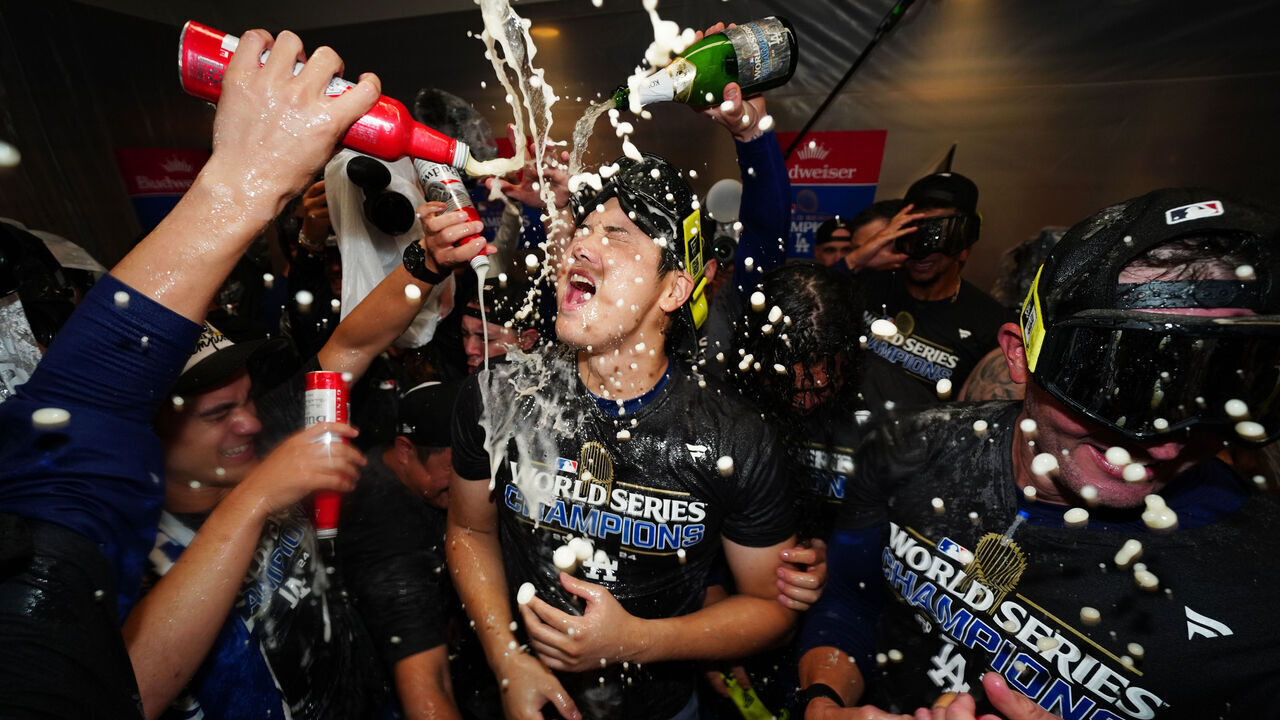 NEW YORK, NY - OCTOBER 30: Shohei Ohtani #17 of the Los Angeles Dodgers celebrates with teammates in the clubhouse following the Dodgers' 7-6 victory in Game 5 to win the 2024 World Series presented by Capital One between the Los Angeles Dodgers and the New York Yankees at Yankee Stadium on Wednesday, October 30, 2024 in New York, New York.