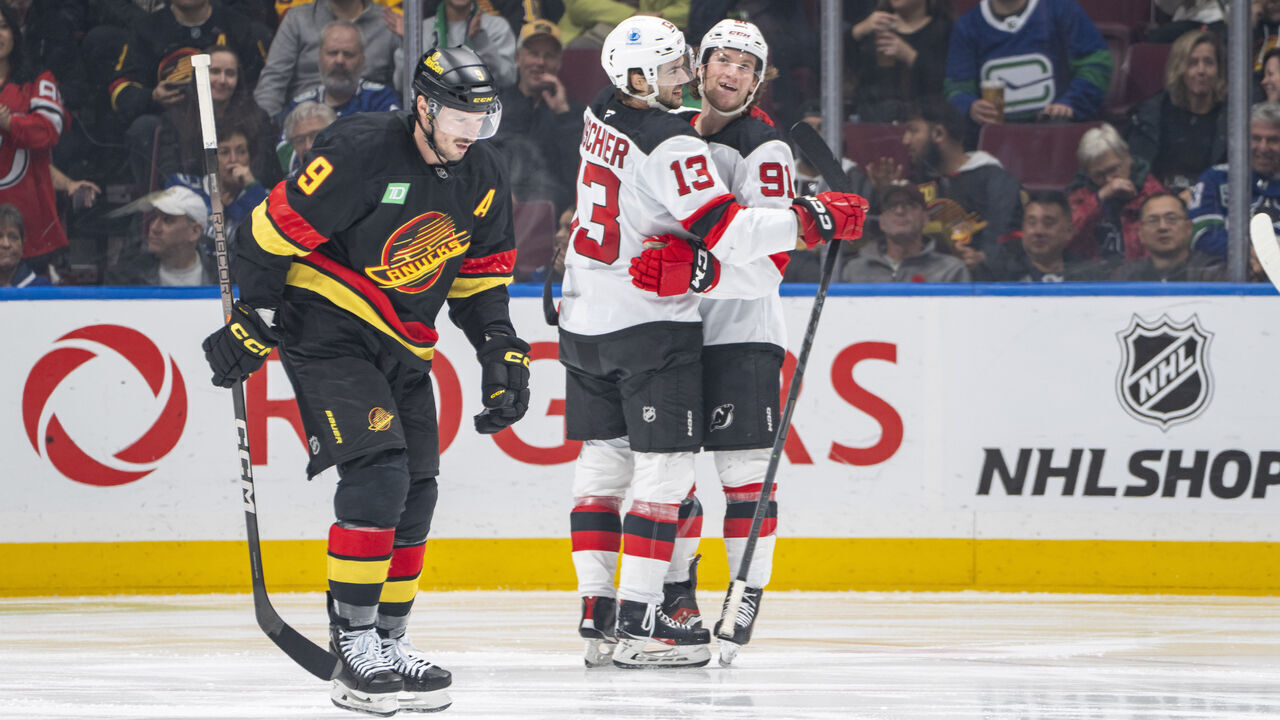 VANCOUVER, CANADA - OCTOBER 30: Dawson Mercer #91 of the New Jersey Devils celebrates his goal with Nico Hischier #13 as J.T. Miller #9 of the Vancouver Canucks skates on dejected during the second period of their NHL game at Rogers Arena on October 30, 2024 in Vancouver, British Columbia, Canada.