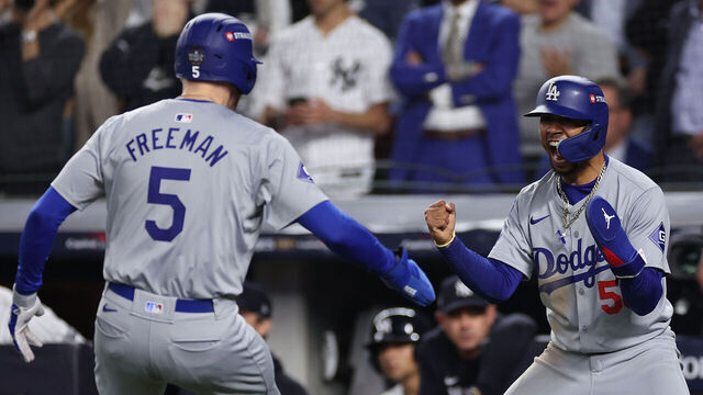 NEW YORK, NEW YORK - OCTOBER 30: Freddie Freeman #5 and Mookie Betts #50 of the Los Angeles Dodgers celebrate after both scored on a two-RBI double by Teoscar Hernández #37 during the fifth inning of Game Five of the 2024 World Series against the New York Yankees at Yankee Stadium on October 30, 2024 in the Bronx borough of New York City.