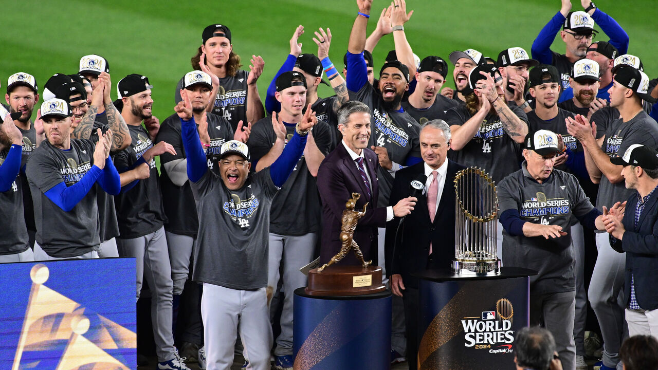 NEW YORK, NY - OCTOBER 30: Members of the Los Angeles Dodgers are presented with the Commissioner's Trophy after winning Game 5 to win the 2024 World Series presented by Capital One between the Los Angeles Dodgers and the New York Yankees at Yankee Stadium on Wednesday, October 30, 2024 in New York, New York.