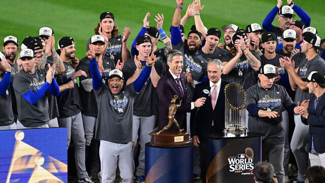 NEW YORK, NY - OCTOBER 30: Members of the Los Angeles Dodgers are presented with the Commissioner's Trophy after winning Game 5 to win the 2024 World Series presented by Capital One between the Los Angeles Dodgers and the New York Yankees at Yankee Stadium on Wednesday, October 30, 2024 in New York, New York.