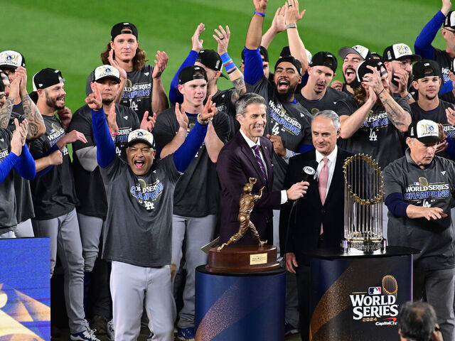 NEW YORK, NY - OCTOBER 30: Members of the Los Angeles Dodgers are presented with the Commissioner's Trophy after winning Game 5 to win the 2024 World Series presented by Capital One between the Los Angeles Dodgers and the New York Yankees at Yankee Stadium on Wednesday, October 30, 2024 in New York, New York.