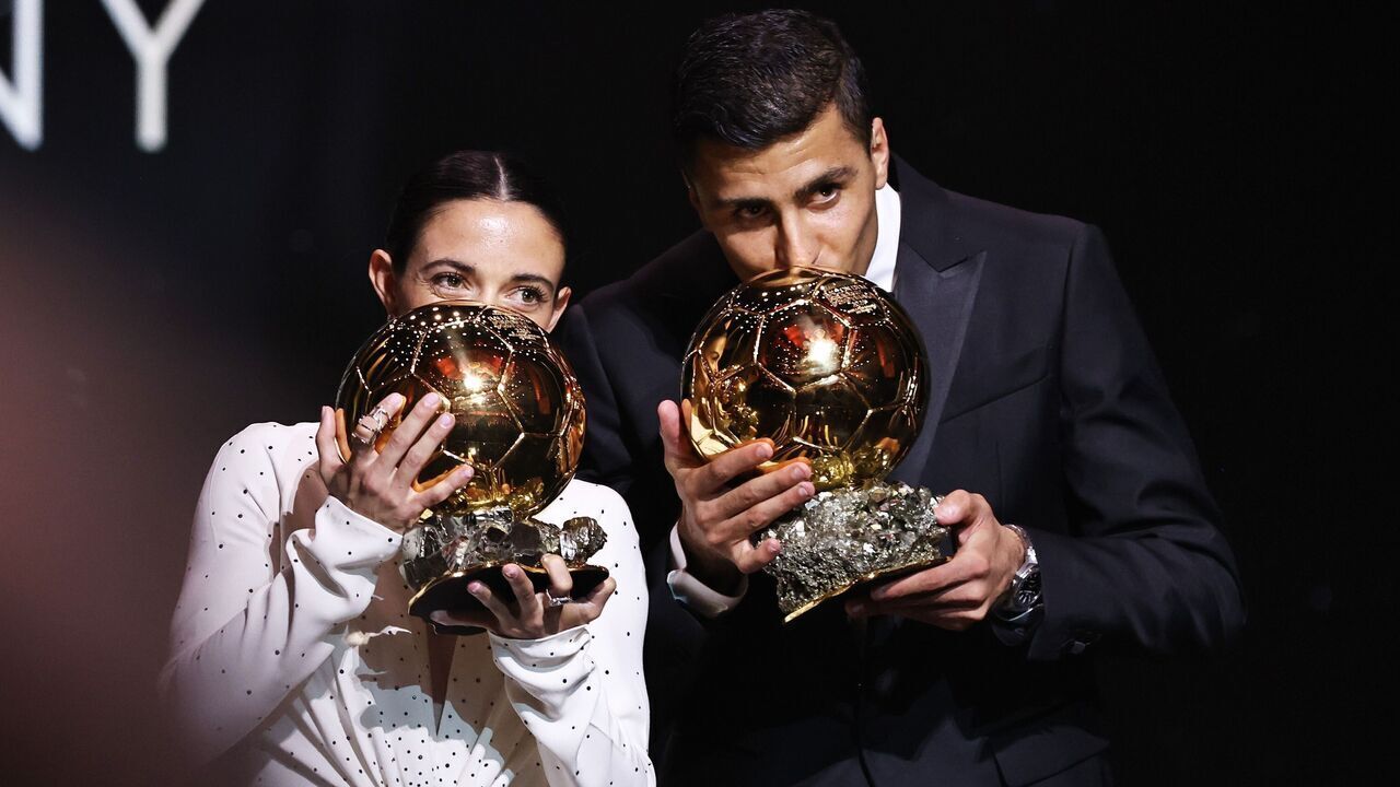 Barcelona's Spanish player Aitana Bonmati L and Manchester City's Spanish player Rodri kiss their trophies during the 2024 Ballon d'Or France Football award ceremony at the Theatre du Chatelet in Paris, France, Oct. 28, 2024.
