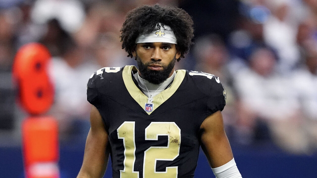 ARLINGTON, TEXAS - SEPTEMBER 15: Chris Olave #12 of the New Orleans Saints looks on during the second half against the Dallas Cowboys at AT&T Stadium on September 15, 2024 in Arlington, Texas.