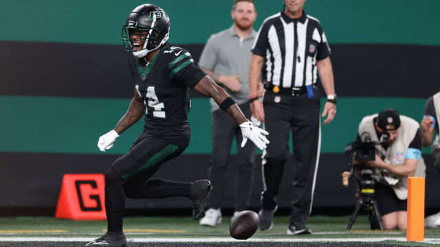 EAST RUTHERFORD, NEW JERSEY - OCTOBER 31: Malachi Corley #14 of the New York Jets drops the ball prior to entering the end zone during the second quarter against the Houston Texans at MetLife Stadium on October 31, 2024 in East Rutherford, New Jersey.