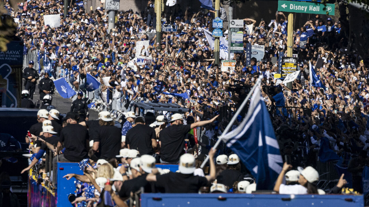 Los Angeles Dodgers' players, staff, families and friends celebrate with fans during the Dodgers' World Series championship parade in downtown Los Angeles on November 1, 2024. The Los Angeles Dodgers punished a string of defensive blunders from the New York Yankees to win the World Series on October 30 with a stunning come-from-behind 7-6 victory.