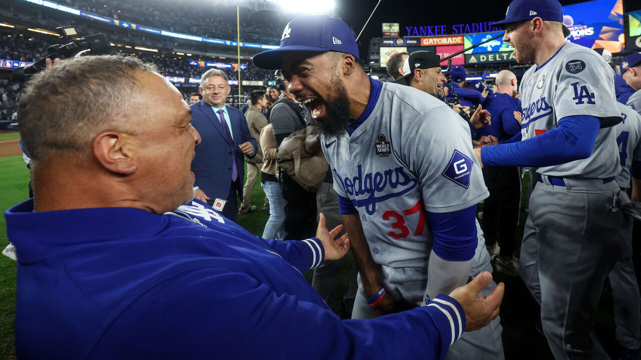 NEW YORK, NY - OCTOBER 30: Manager Dave Roberts #30 and Teoscar Hernandez #37 of the Los Angeles Dodgers celebrate after winning Game 5 of the 2024 World Series presented by Capital One between the Los Angeles Dodgers and the New York Yankees at Yankee Stadium on Wednesday, October 30, 2024 in New York, New York. The Los Angeles Dodgers won 7-6.