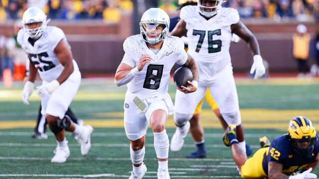 ANN ARBOR, MI - NOVEMBER 2: Dillon Gabriel #8 of Oregon rushes for a touchdown during a game between University of Oregon and University of Michigan at Michigan Stadium on November 2, 2024 in Ann Arbor, Michigan.