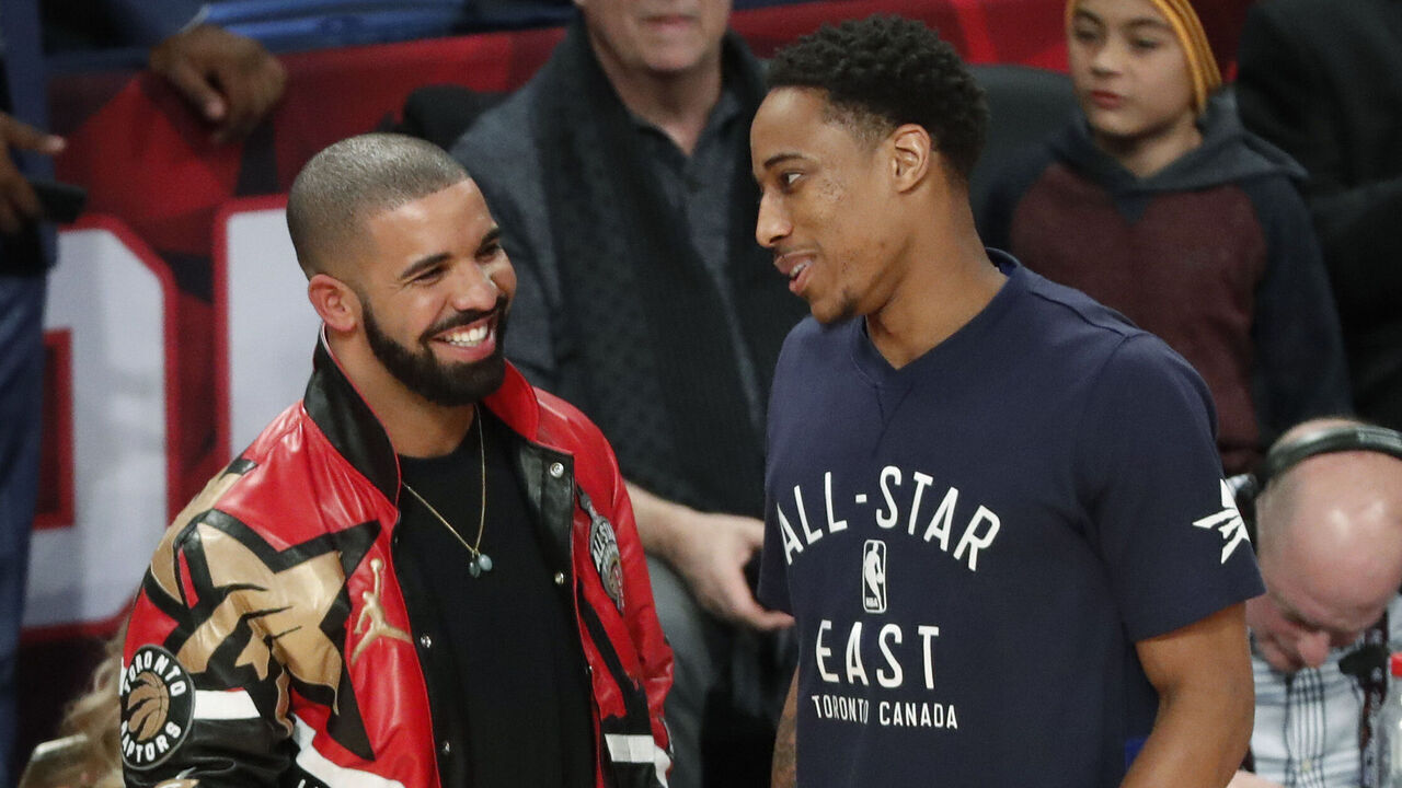 TORONTO, ON - FEBRUARY 14: Canadian rapper Drake talks to Eastern Conference Toronto Raptors DeMar DeRozan (10) during half time in the NBA all-star game in Toronto, Ontario. Toronto Star/Todd Korol (Todd Korol/Toronto Star via Getty Images)
