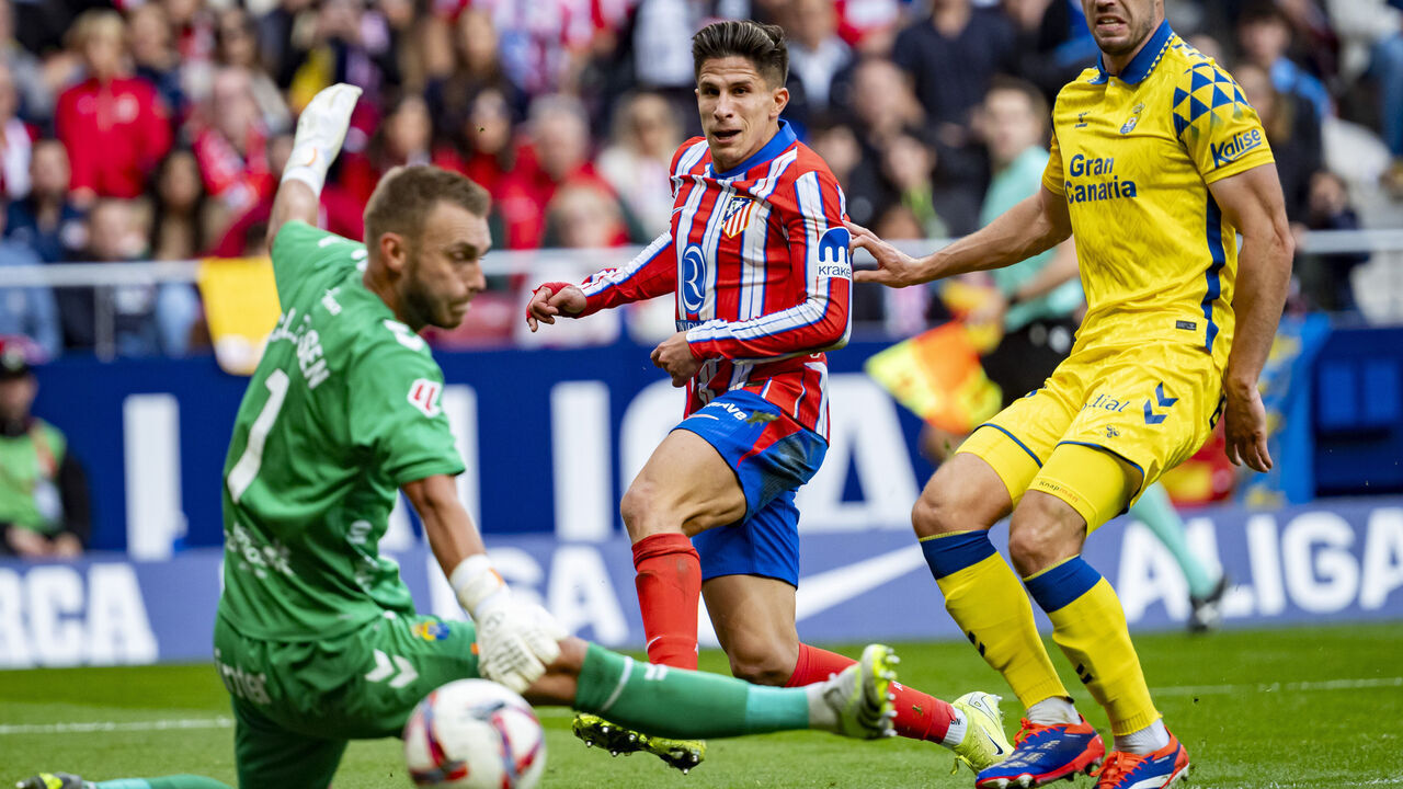 Giuliano Simeone of Atletico de Madrid (C) attempts a kick to score a goal between Jacobus Cillessen of UD Las Palmas (L) and Scott McKenna of UD Las Palmas (R) during the La Liga EA Sports 2024/25 football match between Atletico de Madrid and UD Las Palmas at Estadio Riyadh Air Metropolitano in Madrid, Spain, on November 3, 2024.