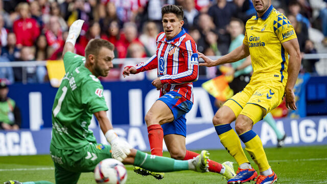 Giuliano Simeone of Atletico de Madrid (C) attempts a kick to score a goal between Jacobus Cillessen of UD Las Palmas (L) and Scott McKenna of UD Las Palmas (R) during the La Liga EA Sports 2024/25 football match between Atletico de Madrid and UD Las Palmas at Estadio Riyadh Air Metropolitano in Madrid, Spain, on November 3, 2024.
