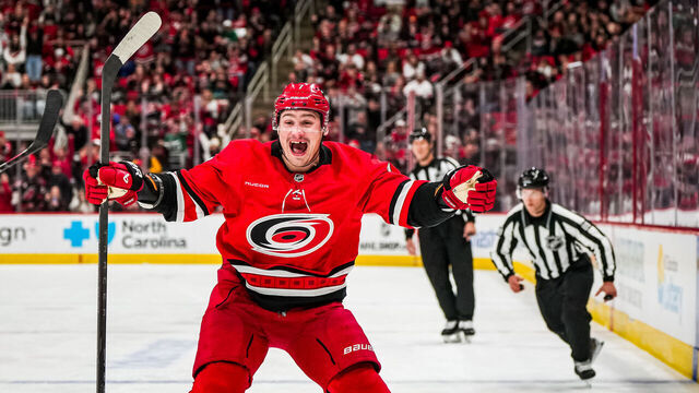RALEIGH, NORTH CAROLINA - OCTOBER 15: Dmitry Orlov #7 of the Carolina Hurricanes celebrates after assisting on a goal by Jackson Blake #53 during the third period against the New Jersey Devils at Lenovo Center on October 15, 2024 in Raleigh, North Carolina.