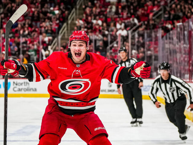 RALEIGH, NORTH CAROLINA - OCTOBER 15: Dmitry Orlov #7 of the Carolina Hurricanes celebrates after assisting on a goal by Jackson Blake #53 during the third period against the New Jersey Devils at Lenovo Center on October 15, 2024 in Raleigh, North Carolina.