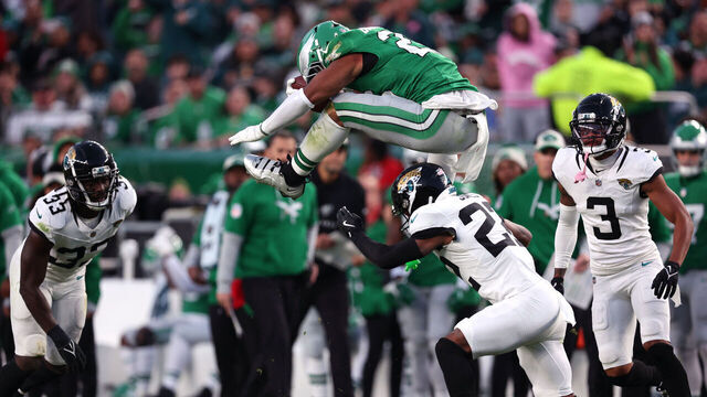 PHILADELPHIA, PENNSYLVANIA - NOVEMBER 03: Saquon Barkley #26 of the Philadelphia Eagles hurdles Jarrian Jones #22 of the Jacksonville Jaguars in the second quarter of a game at Lincoln Financial Field on November 03, 2024 in Philadelphia, Pennsylvania.
