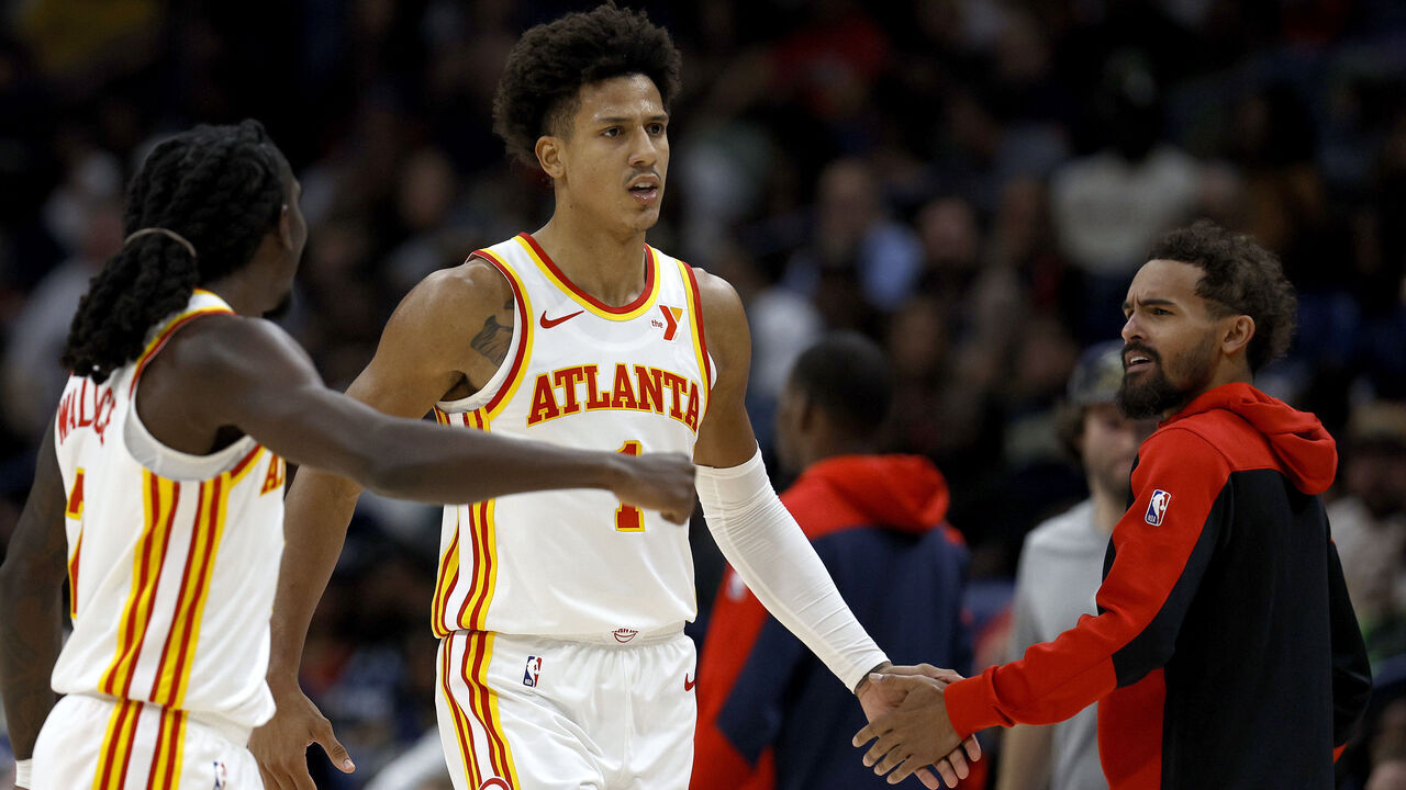 NEW ORLEANS, LOUISIANA - NOVEMBER 03: Jalen Johnson #1 of the Atlanta Hawks slaps hands with Keaton Wallace #2 and Trae Young #11 of the Atlanta Hawks after scoring in the fourth quarter against the New Orleans Pelicans at Smoothie King Center on November 03, 2024 in New Orleans, Louisiana.