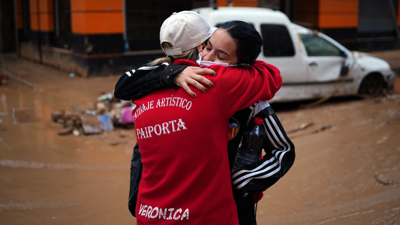Two women hug in Paiporta, in the region of Valencia, eastern Spain, on November 3, 2024, in the aftermath of devastating deadly floods. The death toll from Spain's worst floods in a generation has climbed to 217, rescuers said today.