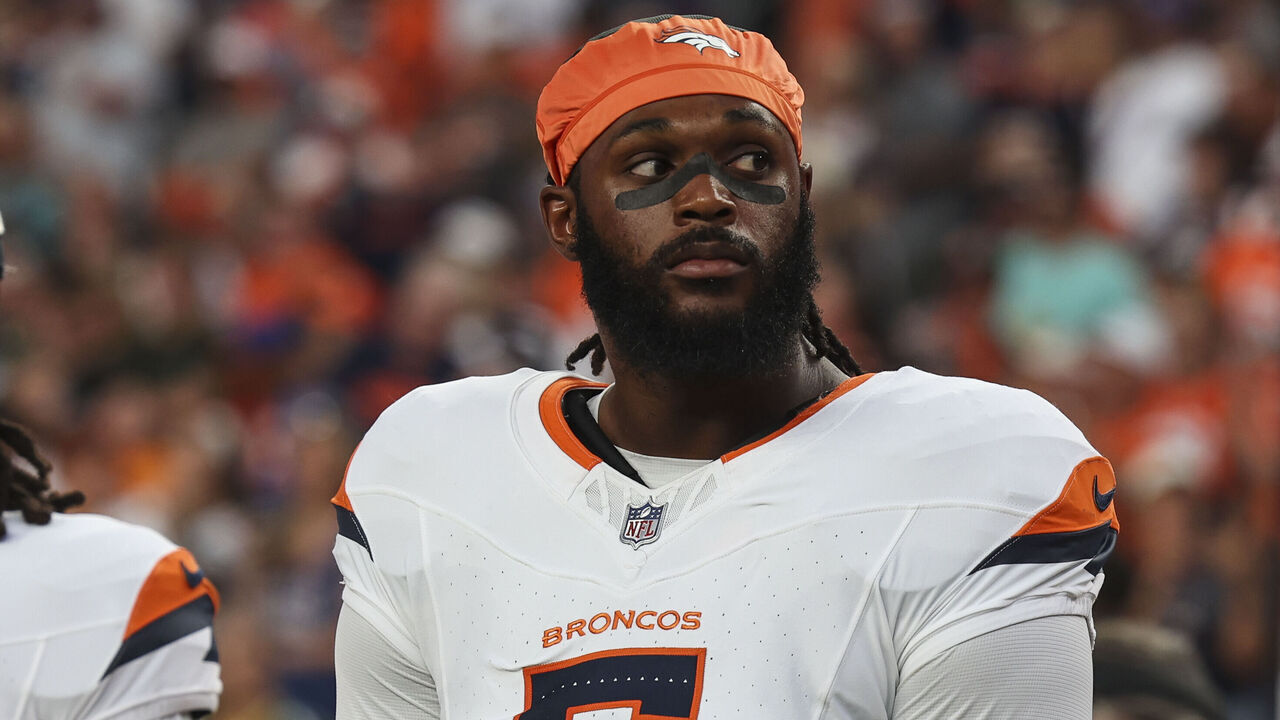 DENVER, CO - AUGUST 18: Baron Browning #5 of the Denver Broncos looks on from the sideline during the national anthem prior to an NFL football game against the Green Bay Packers at Empower Field at Mile High on August 18, 2024 in Denver, CO.