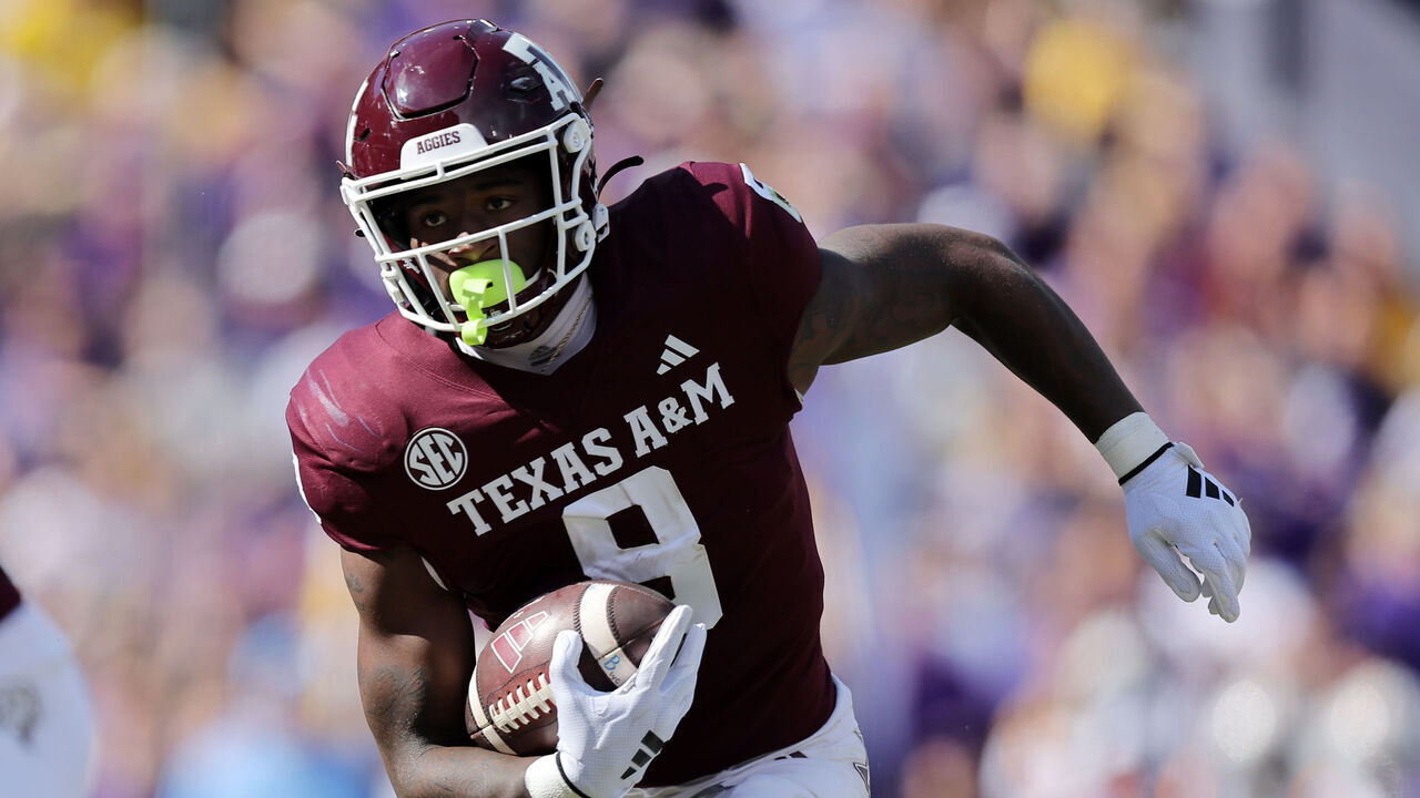 BATON ROUGE, LOUISIANA - NOVEMBER 25: Le'Veon Moss #8 of the Texas A&M Aggies runs with the ball against the LSU Tigers during a game at Tiger Stadium on November 25, 2023 in Baton Rouge, Louisiana.