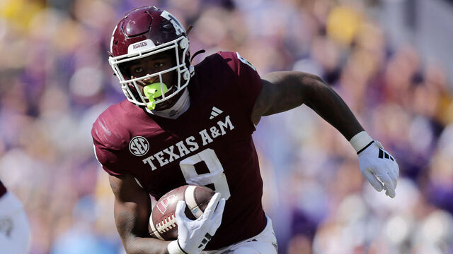 BATON ROUGE, LOUISIANA - NOVEMBER 25: Le'Veon Moss #8 of the Texas A&M Aggies runs with the ball against the LSU Tigers during a game at Tiger Stadium on November 25, 2023 in Baton Rouge, Louisiana.