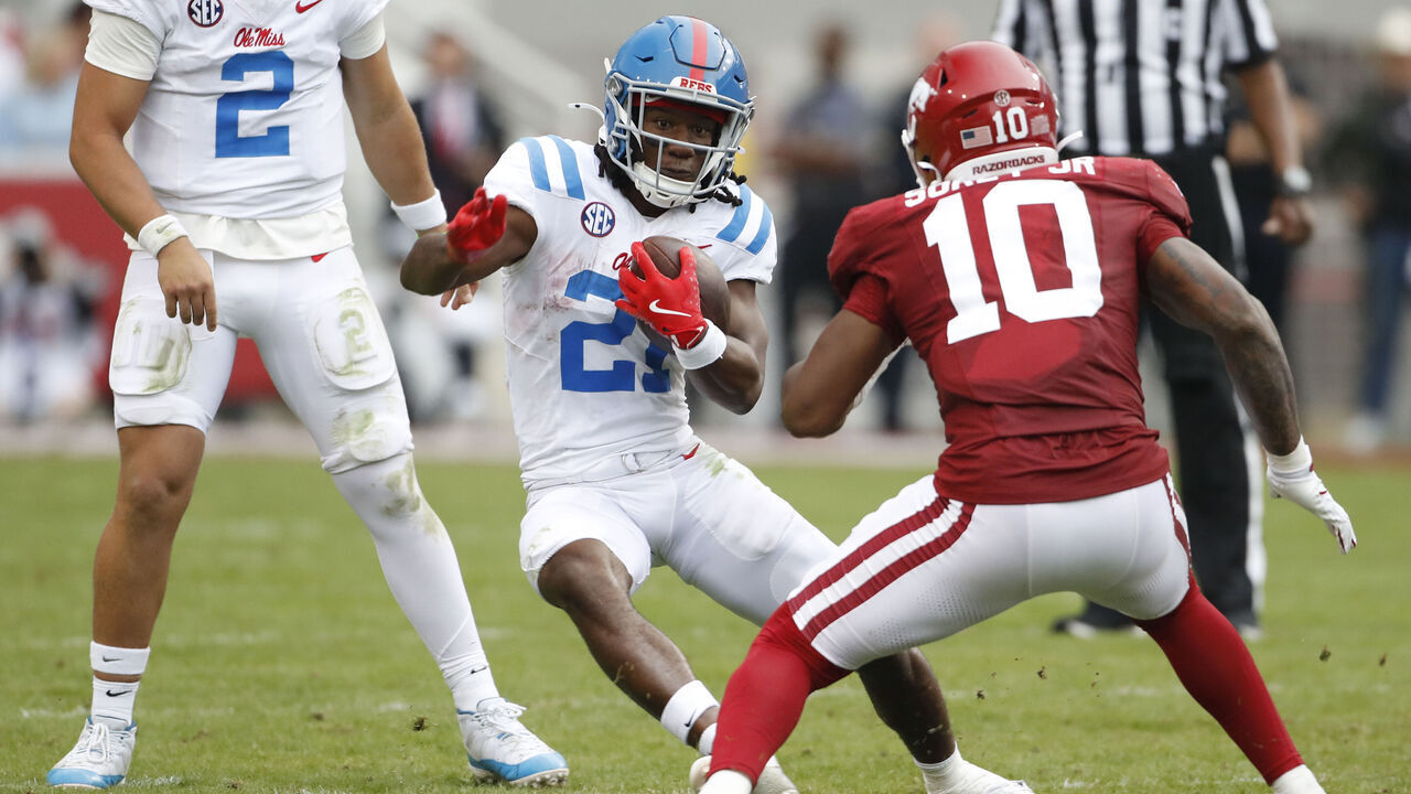 FAYETTEVILLE, AR - NOVEMBER 02: Mississippi Rebels running back Henry Parrish Jr. (21) attempts to elude Arkansas Razorbacks linebacker Xavian Sorey Jr. (10) during the college football game between the Mississippi Rebels and Arkansas Razorbacks on November 2, 2024, at Donald W. Reynolds Razorback Stadium in Fayetteville, Arkansas.