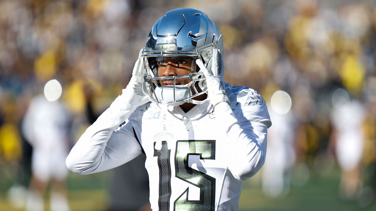 ANN ARBOR, MI - NOVEMBER 2: Tez Johnson #15 of the Oregon Ducks loosens his helmet before a game between University of the Oregon Ducks and University of the Michigan Wolverines at Michigan Stadium on November 2, 2024 in Ann Arbor, Michigan.
