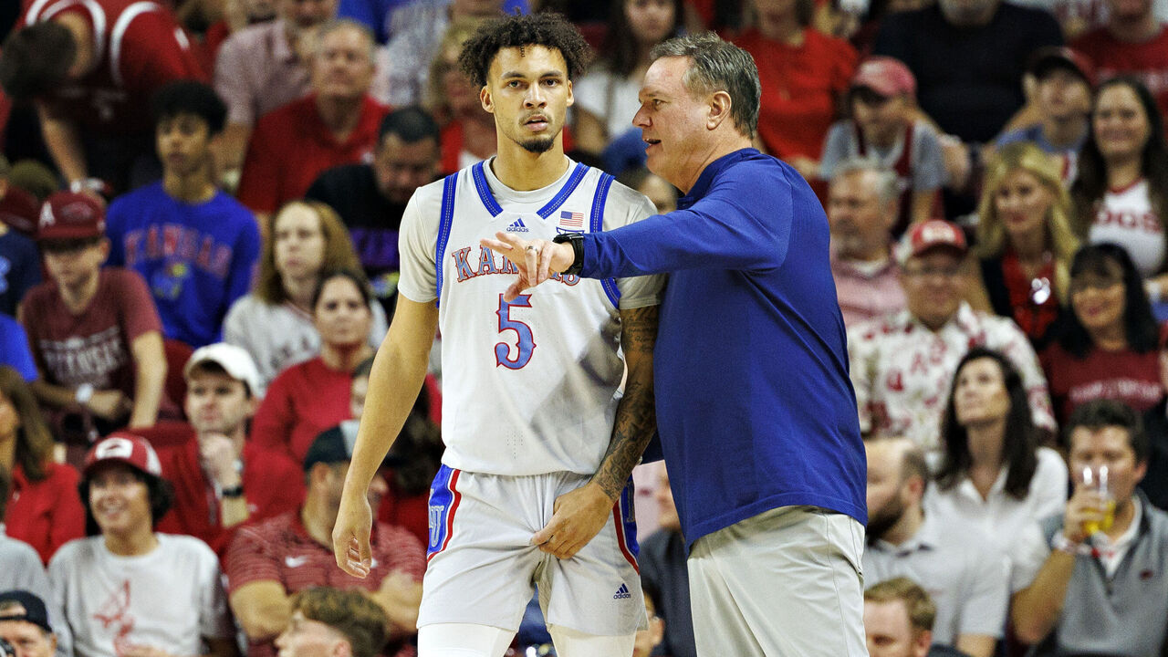 FAYETTEVILLE, ARKANSAS - OCTOBER 25: Head Coach Bill Self talks with Zeke Mayo #5 of the Kansas Jayhawks during a game against the Arkansas Razorbacks at Bud Walton Arena on October 25, 2024 in Fayetteville, Arkansas. The Razorbacks defeated the Jayhawks 85-69.