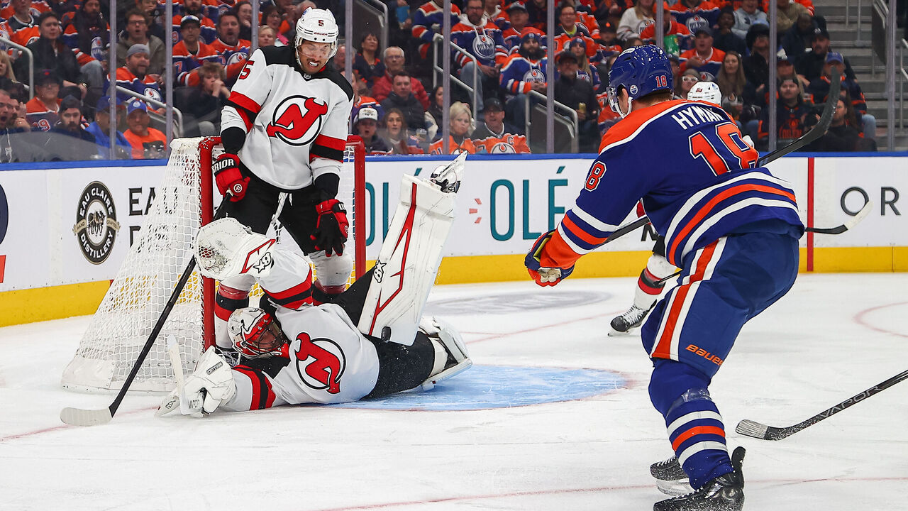 EDMONTON, AB - NOVEMBER 4: New Jersey Devils Goalie Jake Allen (23) makes a big save on Edmonton Oilers Right Wing Zach Hyman (18) in the first period of the Edmonton Oilers game versus the New Jersey Devils on November 4, 2024 at Rogers Place in Edmonton, AB.