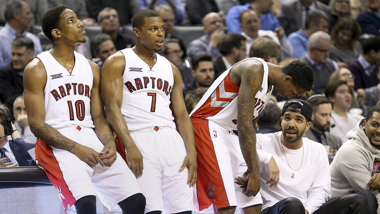 Toronto, Canada - February 11 - In first half action, Drake chats with Toronto Raptors guard Louis Williams (23) as DeRozan and Lowry wait out a time out. The Toronto Raptors took on the Washington Wizards at the Air Canada Centre in Toronto. February 11, 2015 (Richard Lautens/Toronto Star via Getty Images)
